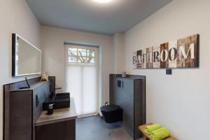 a room with a bathroom with a sink and a mirror at Insel-Juwel im Lindenhof in Wangerooge +10 photos