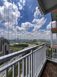 a view from the balcony of a building with glass windows at Homely Stay by MySky Stays at Presint 5, Putrajaya in Putrajaya