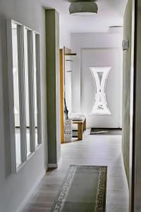 a hallway with green and white walls and a rug at Fewo Waldfeeling in Brilon