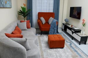 a living room with a couch and a chair at The Swanky Crib in Ruiru