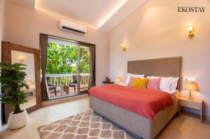 a bedroom with a bed and a large window at EKOSTAY - White Lotus in Karjat +27 photos