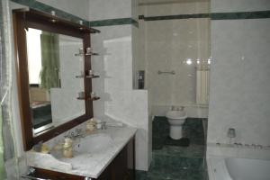 a bathroom with a sink and a toilet and a mirror at Casa Vacanze Chiara in Terni