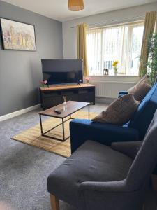 a living room with a couch and a coffee table at Sunderland Castle Free Parking in Sunderland
