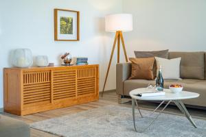a living room with a couch and a table at Terrassenwohnung "Haffromantik" in Garz