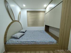 a bedroom with a bed and a window in it at Nhà Nắng Vàng in Hai Phong