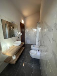 a bathroom with two sinks and a mirror at Castle Charm Apartment, MantegnaHotels in Mantova