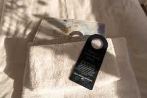 a book sitting on top of a white blanket at HOTEL SØMA Ilulissat in Ilulissat