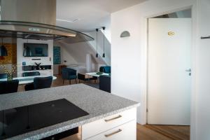a kitchen and living room with a counter top at HOTEL SØMA Ilulissat in Ilulissat
