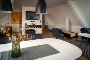 a living room with a white table and chairs at HOTEL SØMA Ilulissat in Ilulissat
