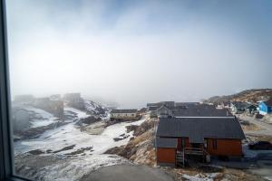 a group of houses on top of a mountain at HOTEL SØMA Ilulissat in Ilulissat