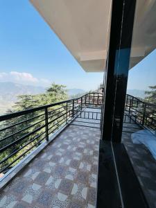 a view from the balcony of a house at Ambrosia Grand in Shimla +16 photos