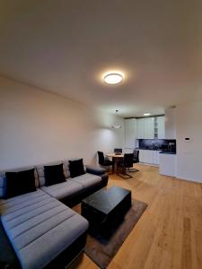 a living room with a couch and a table at Big Balcony & Free parking - PREMIUM Apartment in Bratislava