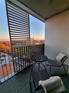 a balcony with a table and chairs and a view at Big Balcony & Free parking - PREMIUM Apartment in Bratislava