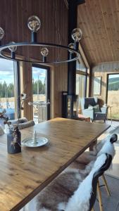 a large wooden table in a room with a fireplace at Cabin Lillehammer, Nordseter, Sjusjøen in Lillehammer
