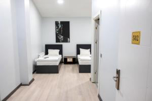 A bed or beds in a room at ZOOM HOTEL