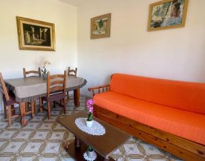 a living room with a couch and a table at FELYX APARTMENT - Bright, Spacious, and 100 mt from the waves - Lavinio Mare in Anzio