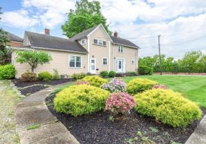 a house with bushes in the front yard at Double the Space for Large Groups Entire Duplex in Cleveland