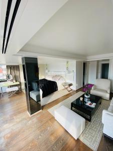 a large living room with a bed and a couch at GRAY D ALBION Residence in Cannes