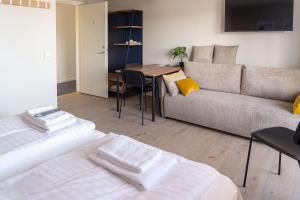 a living room with a couch and a table at HOTEL SØMA Ilulissat in Ilulissat