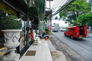 a red truck parked on the side of a street at GOYA hotel in Chiang Mai