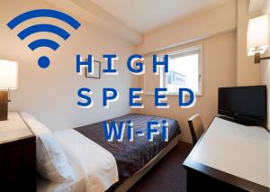 a hotel room with a bed with a wifi sign on the wall at Meitetsu Inn Nagoya Nishiki in Nagoya