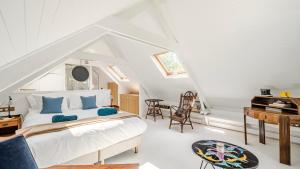 a bedroom with a white bed in a attic at Villa Samzun 5 bedrooms in Bangor