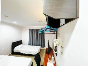 Postel nebo postele na pokoji v ubytování OYO 91150 Hotel Tasik Utama