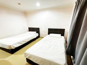 Postel nebo postele na pokoji v ubytování OYO 91150 Hotel Tasik Utama
