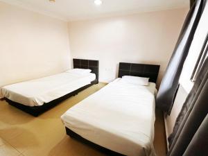 Postel nebo postele na pokoji v ubytování OYO 91150 Hotel Tasik Utama