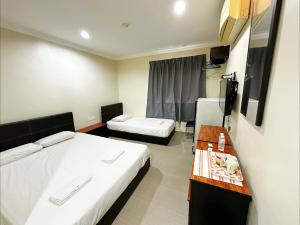 Postel nebo postele na pokoji v ubytování OYO 91150 Hotel Tasik Utama