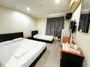 Postel nebo postele na pokoji v ubytování OYO 91150 Hotel Tasik Utama