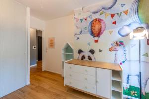a childs bedroom with a white dresser and a wall mural at Stunning 3Bedroom Apartment with Garden in Prestigious Area I Eiffel Tower Within 15 Minutes' Drive in Issy-les-Moulineaux +54 photos