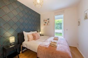 a bedroom with a large bed and a window at Stunning 3Bedroom Apartment with Garden in Prestigious Area I Eiffel Tower Within 15 Minutes' Drive in Issy-les-Moulineaux