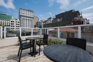 a table and chairs on the roof of a building at Ten Rooms Istanbul Hotel in Istanbul
