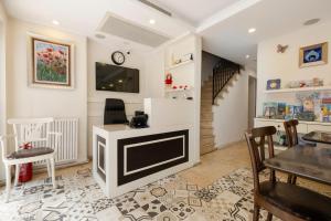 a living room with a television and a table and chairs at Ten Rooms Istanbul Hotel in Istanbul