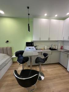 a kitchen with a table and chairs in a room at Bamboo Beach Tsikhisdziri in Tsikhisdziri