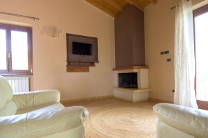 a living room with two couches and a tv at all'ombra dei castagni in Carbognano +7 photos