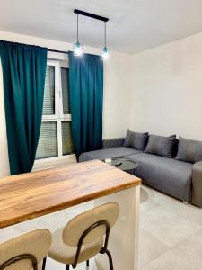 a living room with blue curtains and a couch at LOFT APARTAMENT I Kępno in Kępno +2 photos