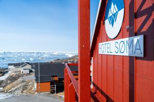 a sign on the side of a building at HOTEL SØMA Ilulissat in Ilulissat