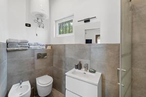Porto Columbu - Perdʼe SaliにあるDependance Villa Matteoのトイレと洗面台を備えた白いバスルーム +18枚の写真