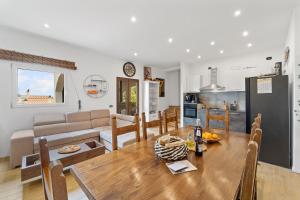 a kitchen and living room with a wooden table at Villa Matteo Suite in Porto Columbu - Perdʼe Sali