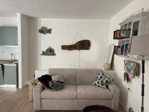 a living room with a couch with a dog laying on it at Casa Frida in Capraia