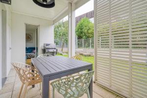 a patio with a table and chairs on a patio at Stunning 3Bedroom Apartment with Garden in Prestigious Area I Eiffel Tower Within 15 Minutes' Drive in Issy-les-Moulineaux