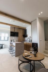 a kitchen and living room with a table and a counter at Poema Antiparos in Antiparos