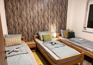 a room with two beds and a wall with a wallpaper at simply-una in Bihać +40 photos