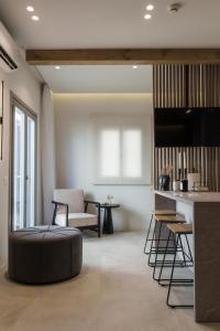 a living room with a large ottoman in the middle at Poema Antiparos in Antiparos
