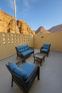 a patio with chairs and a view of the desert at Mountain view in Al-ʿUla