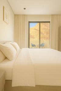 a hotel room with a large bed and a window at Mountain view in Al-ʿUla