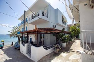 a white building on the side of a street at Sophia's Summer Residence in Tolo