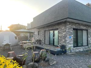 济州市Summer's House的带露台和帐篷的砖房